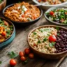 Colorful spread of plant-based diet recipes on a kitchen table
